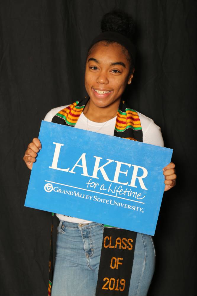a student holding Laker for Lifetime sign
